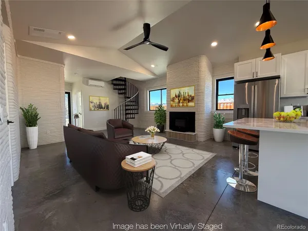 a living room with fireplace furniture and a wooden floor