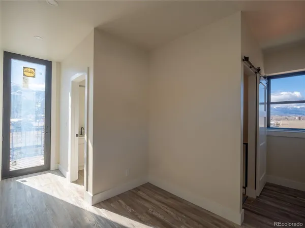 a view of hallway with wooden floor