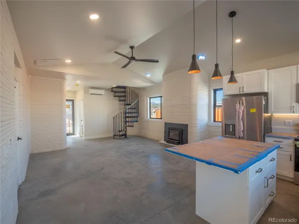a view of a kitchen with a sink and a fireplace