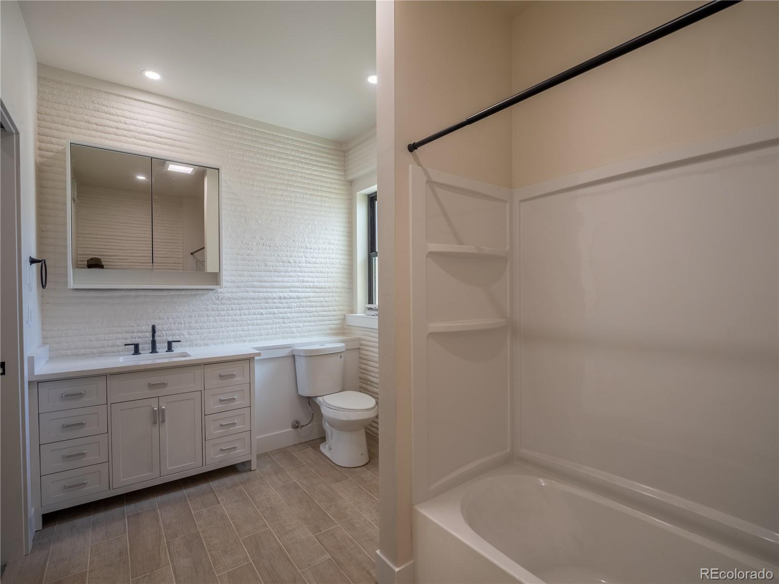 4901 Main Street Salida, CO 81201 - Photo 9 of 14 a bathroom with a sink a toilet and shower