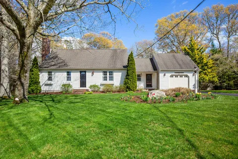 a view of a house with a backyard