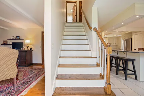 a view of entryway and hall with wooden floor