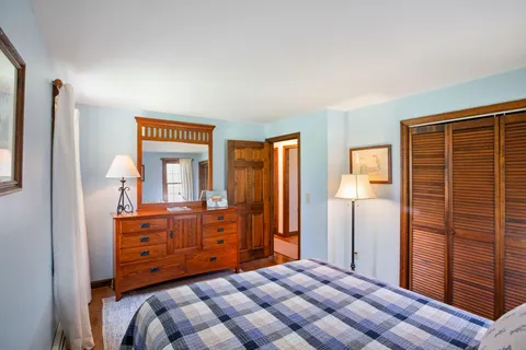 a bedroom with a bed and a dresser