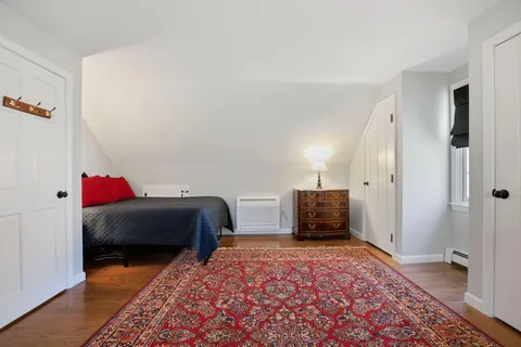 a bedroom with furniture and a window