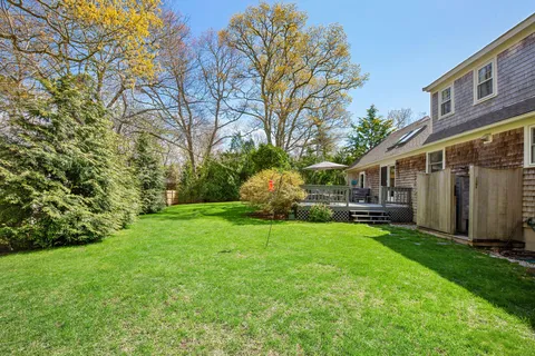 a view of a house with backyard and sitting area