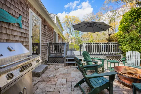a view of a patio with a table and chairs