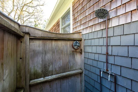 a view of a wooden door and brick wall