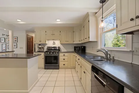 a kitchen with a sink stove and cabinets
