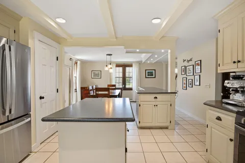a kitchen with stainless steel appliances a refrigerator sink and cabinets