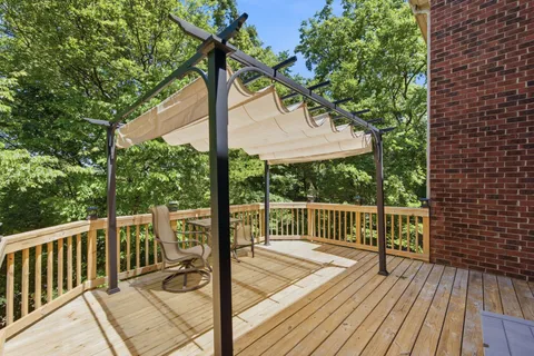 a view of balcony with wooden floor and fence