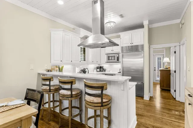 a view of a a dining room with furniture window and wooden floor