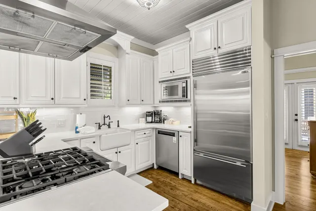 a kitchen with a sink stove and cabinets