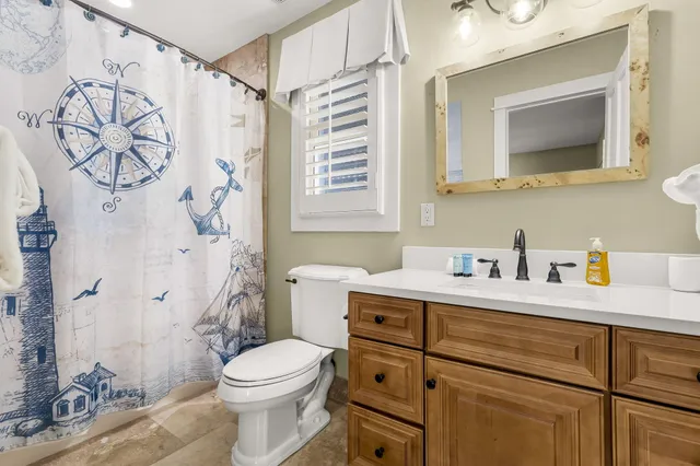 a bedroom with two large bed and a window