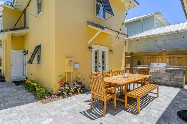 a view of a patio with table and chairs and potted plants