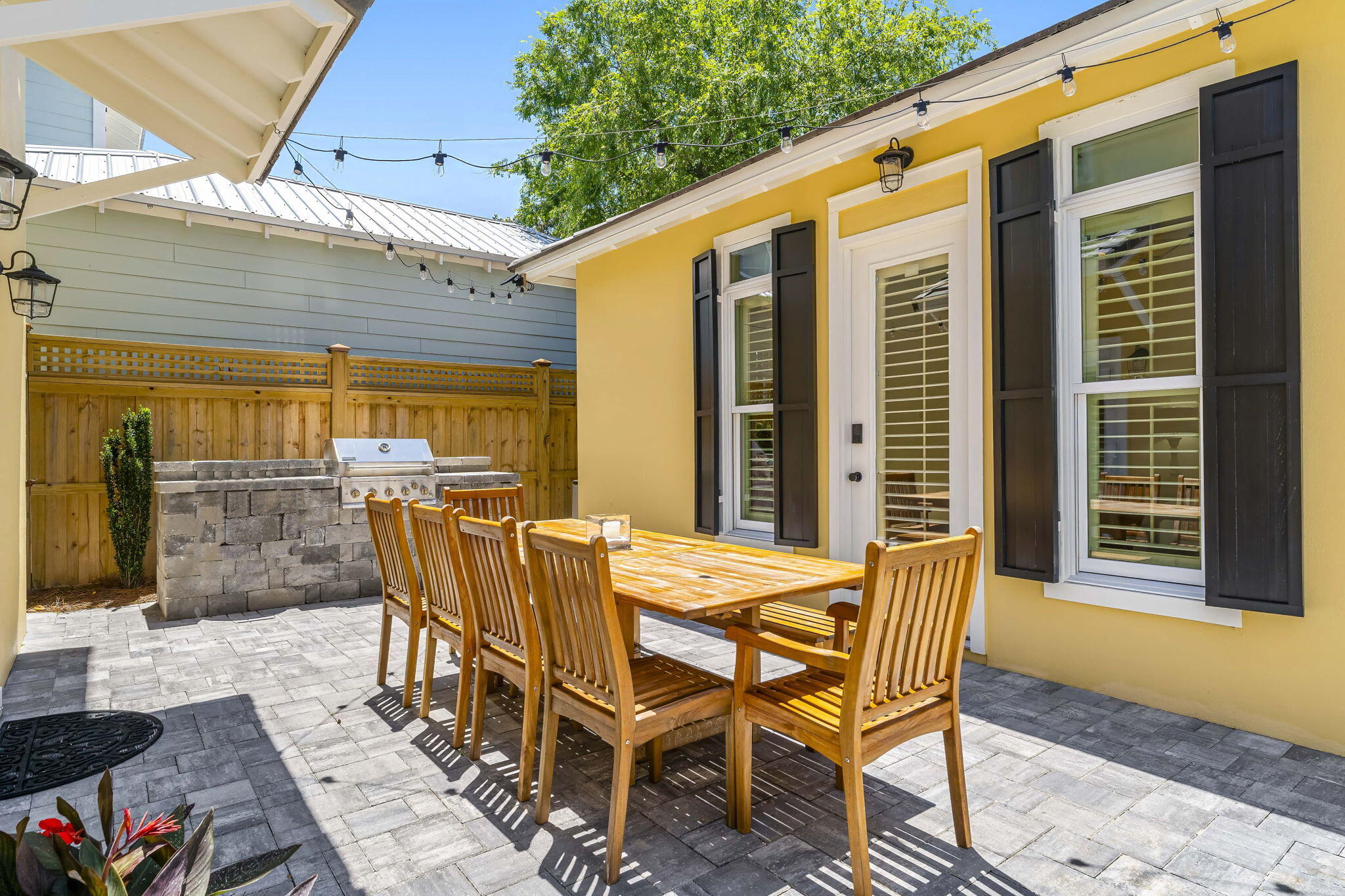 60 Rue Caribe Miramar Beach, FL 32550 - Photo 33 of 43 a view of a patio with table and chairs and potted plants