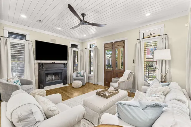 a kitchen with stainless steel appliances granite countertop a stove a sink a oven a dining table and chairs with wooden floor