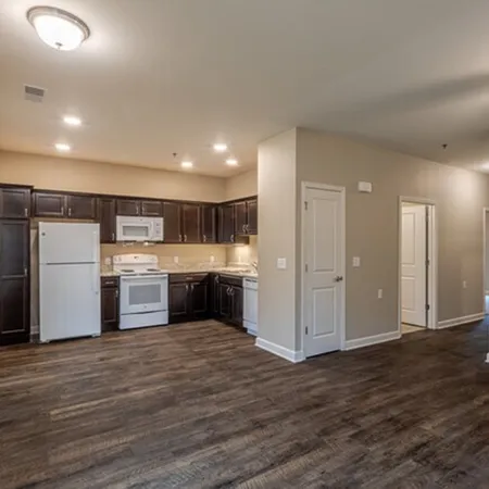 a kitchen with stainless steel appliances kitchen island granite countertop a refrigerator and a stove top oven