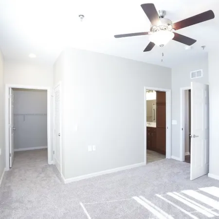 a view of an empty room with a ceiling fan