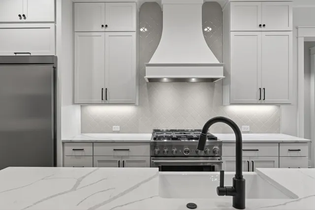 a kitchen with a sink and a stove