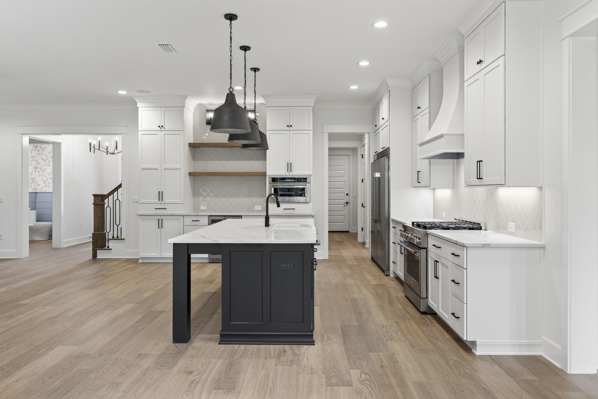 453 Shimmer Circle Freeport, FL 32439 - Photo 14 of 38 a large kitchen with stainless steel appliances granite countertop a stove and a refrigerator