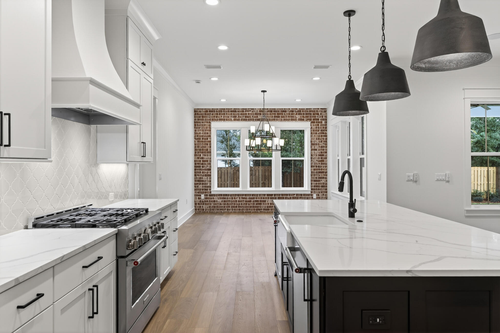 453 Shimmer Circle Freeport, FL 32439 - Photo 16 of 38 a kitchen with granite countertop a stove a sink a refrigerator and wooden floor