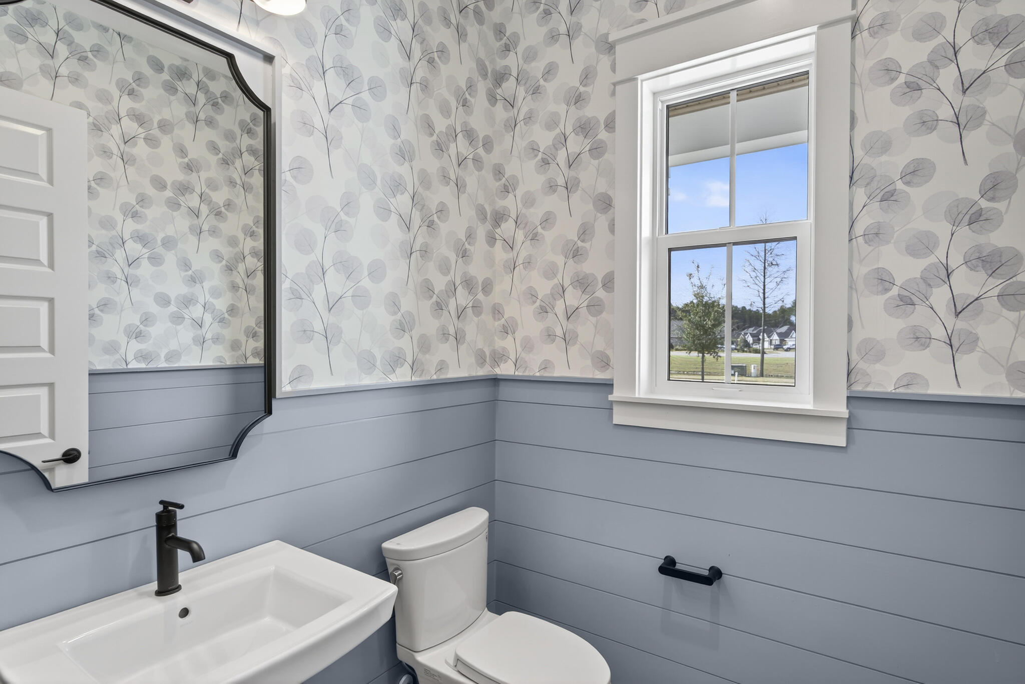 453 Shimmer Circle Freeport, FL 32439 - Photo 33 of 38 a bathroom with a toilet sink and mirror