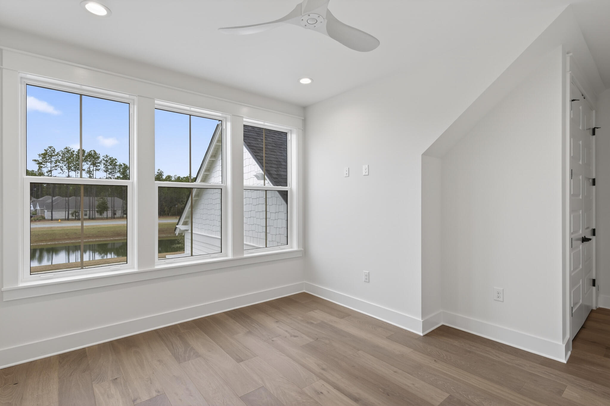 453 Shimmer Circle Freeport, FL 32439 - Photo 36 of 38 a view of an empty room with a window and wooden floor