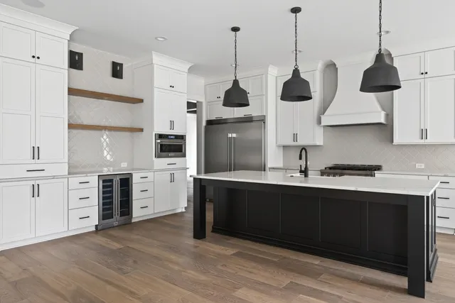 a kitchen with stainless steel appliances sink stove and cabinets
