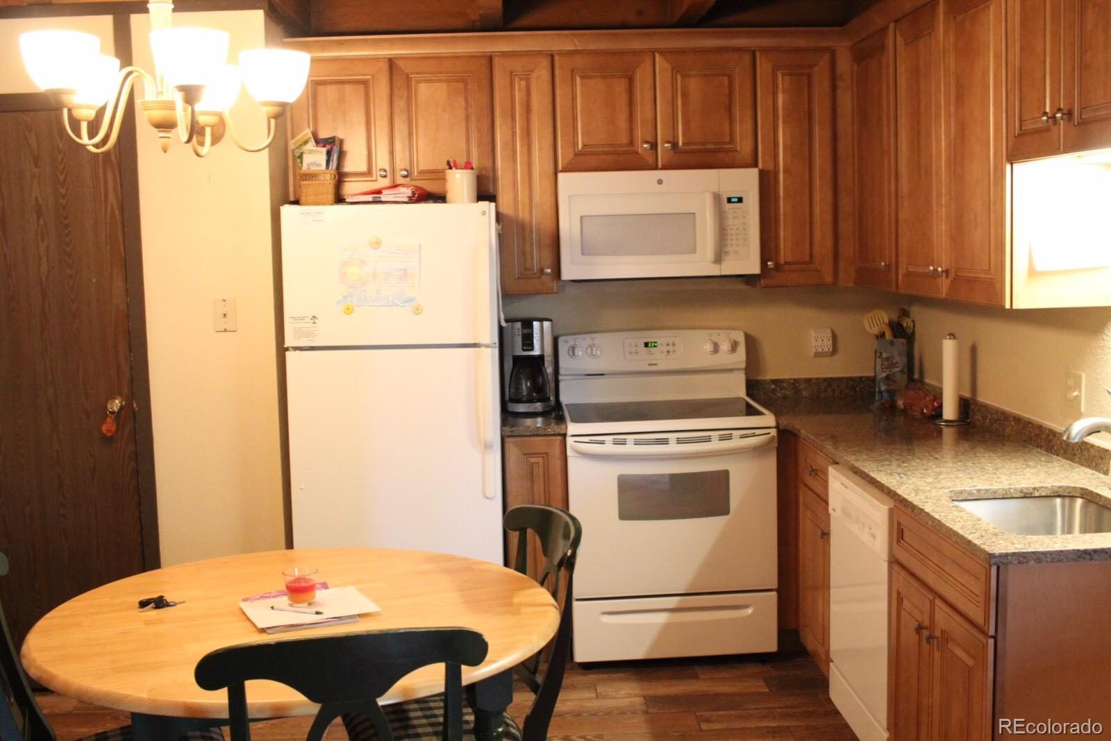 a kitchen with refrigerator and stove