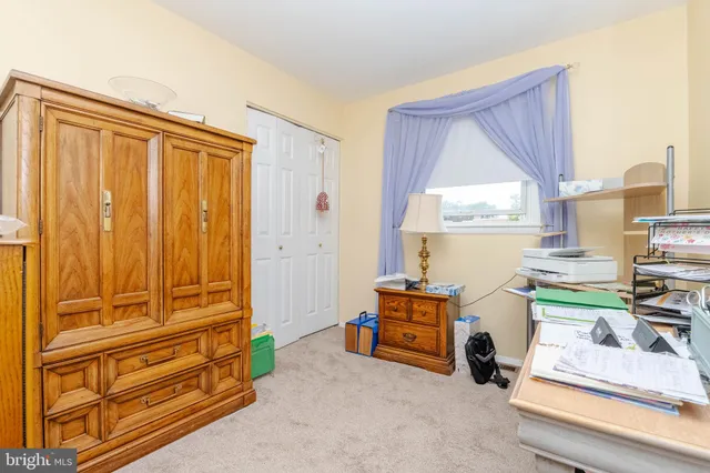 a room with furniture a rug and a window