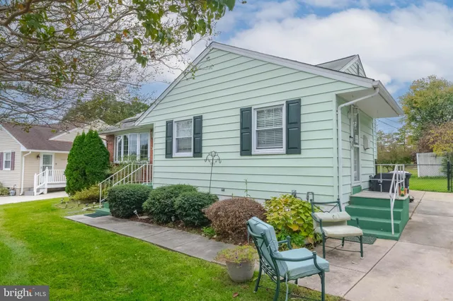 a backyard of a house with table and chairs