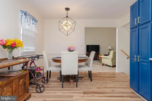 a view of a dining room with furniture and chandelier