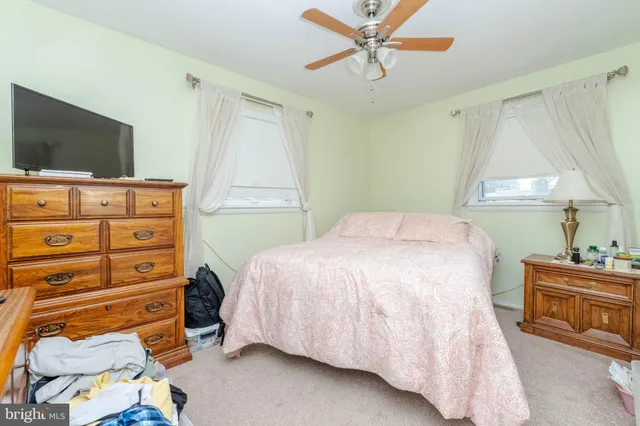 a bedroom with a bed and a flat tv screen in it