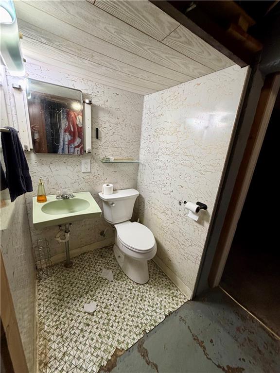 118 Ida Avenue Donora, PA 15033 - Photo 15 of 18 a bathroom with a toilet a sink and mirror