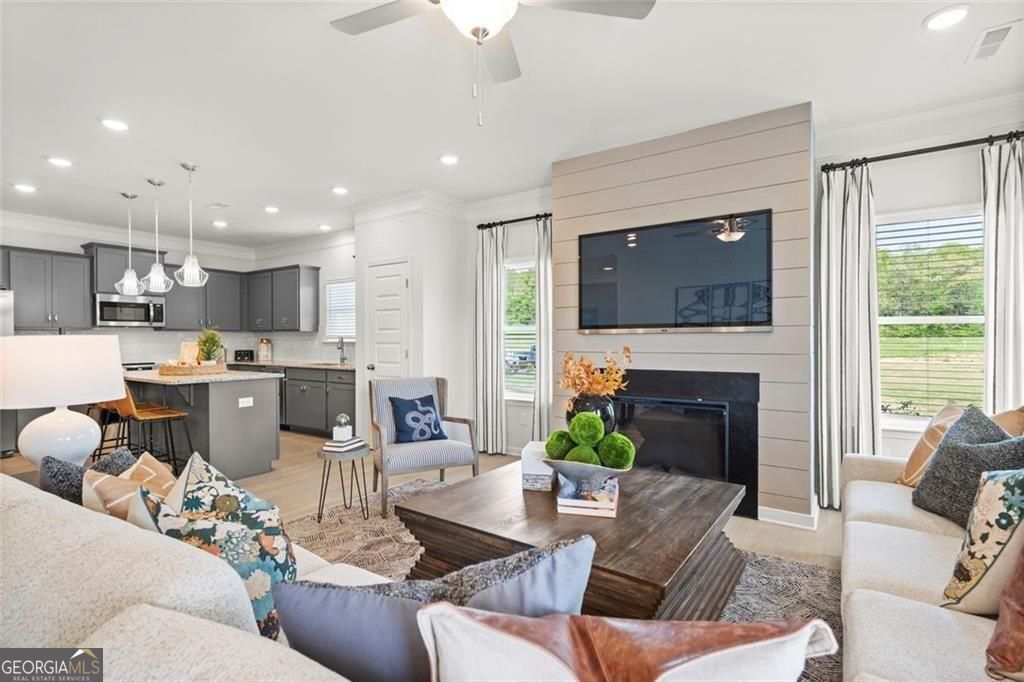 105 Roy Drive Calhoun, GA 30701 - Photo 16 of 28 a living room with furniture a fireplace and a flat screen tv