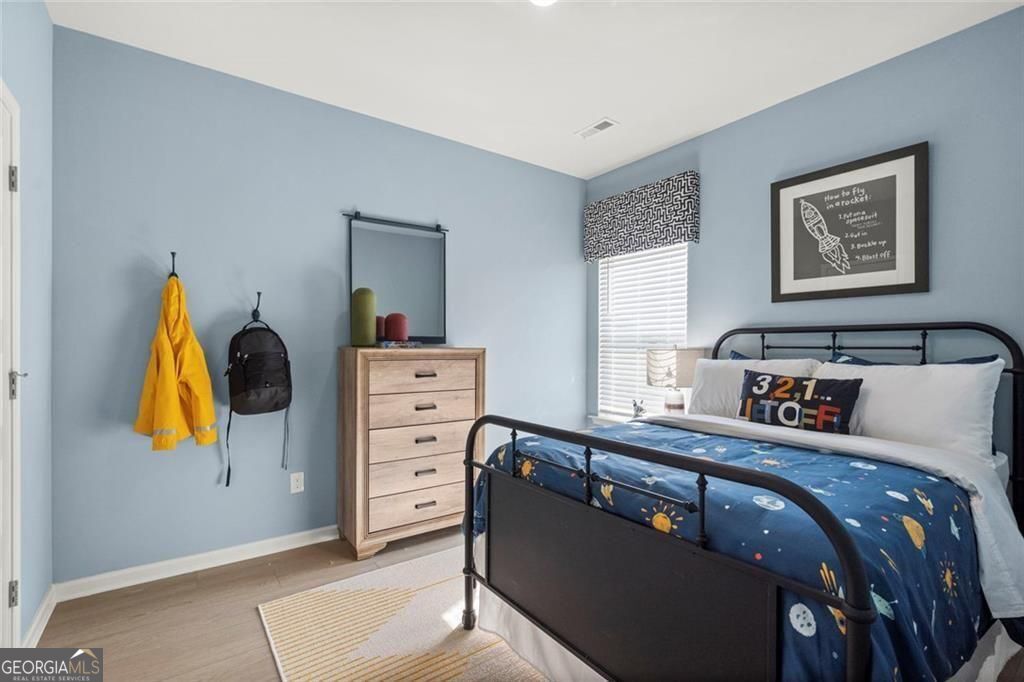 105 Roy Drive Calhoun, GA 30701 - Photo 21 of 28 a bedroom with a bed and furniture
