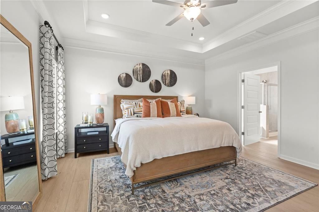 105 Roy Drive Calhoun, GA 30701 - Photo 23 of 28 a bedroom with a bed and a chandelier