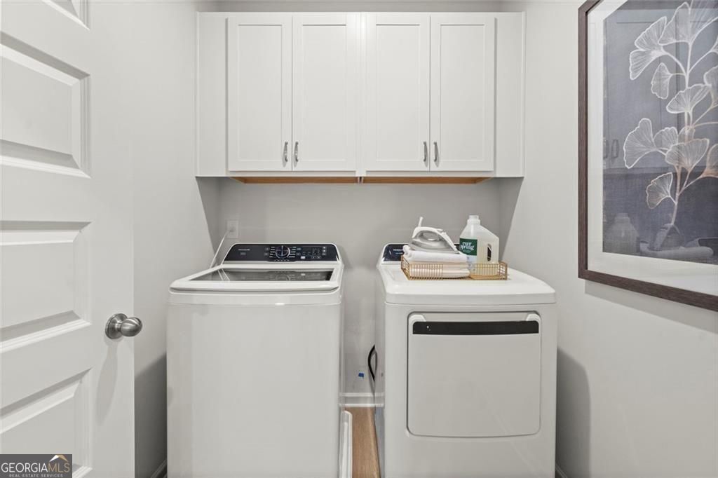 105 Roy Drive Calhoun, GA 30701 - Photo 4 of 28 a view of washer and dryer with white cabinet