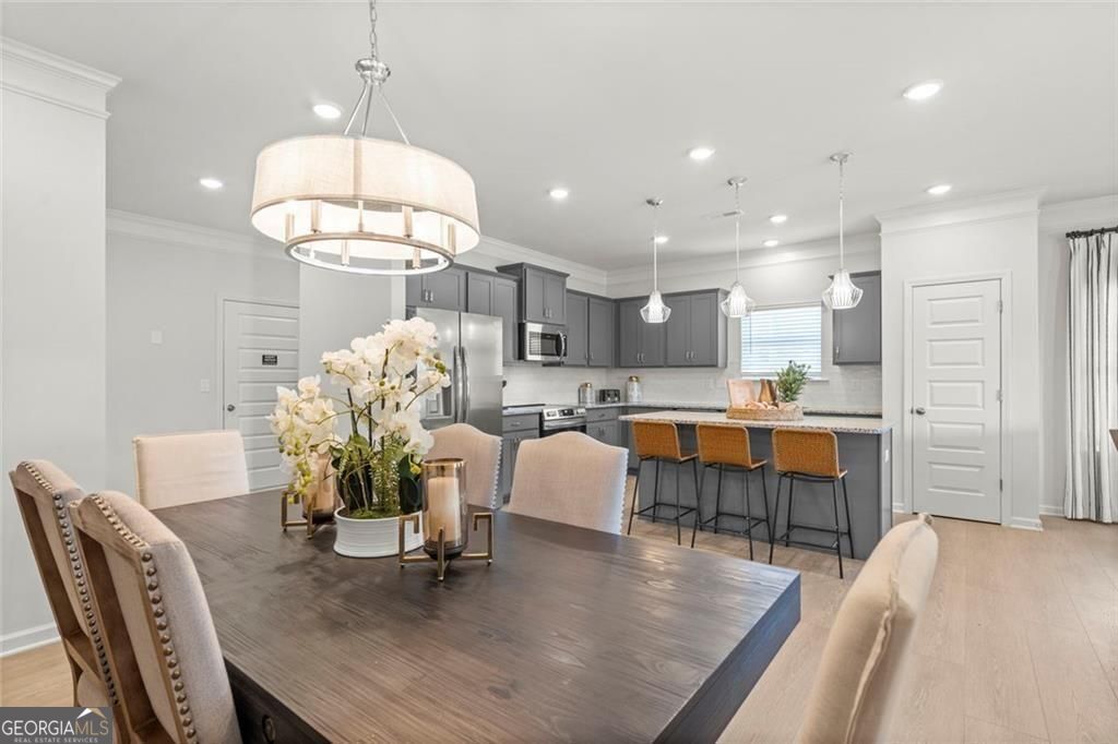 105 Roy Drive Calhoun, GA 30701 - Photo 8 of 28 a dining room filled chandelier and wooden floor