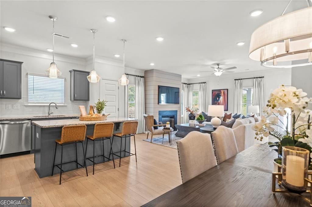 105 Roy Drive Calhoun, GA 30701 - Photo 9 of 28 a large living room with stainless steel appliances kitchen island granite countertop furniture and a dining table