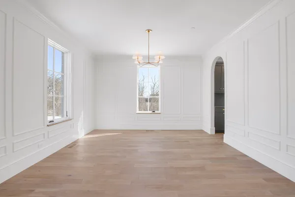 an empty room with windows and closet