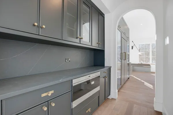 a kitchen with granite countertop a stove and a wooden cabinets