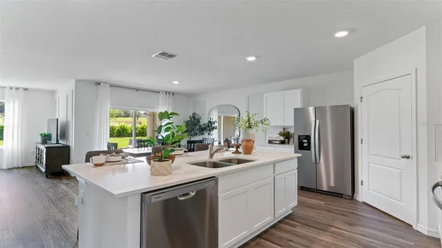a kitchen with stainless steel appliances a sink stove and refrigerator