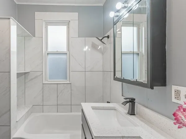 a bathroom with a bathtub and shower