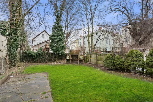 a view of a backyard with a large tree