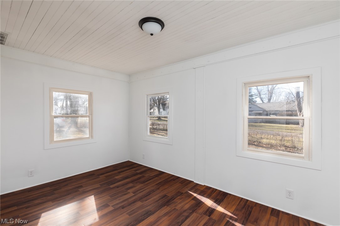 7366 Crossfield Road Mentor, OH 44060 - Photo 11 of 22 Empty room featuring dark hardwood / wood-style floors and a healthy amount of sunlight