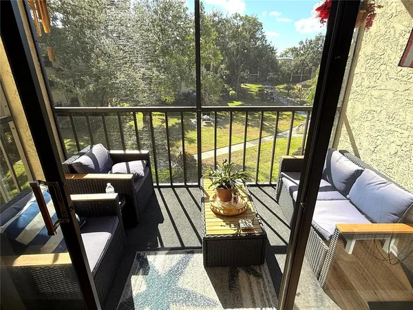 a view of a living room with furniture and a large window