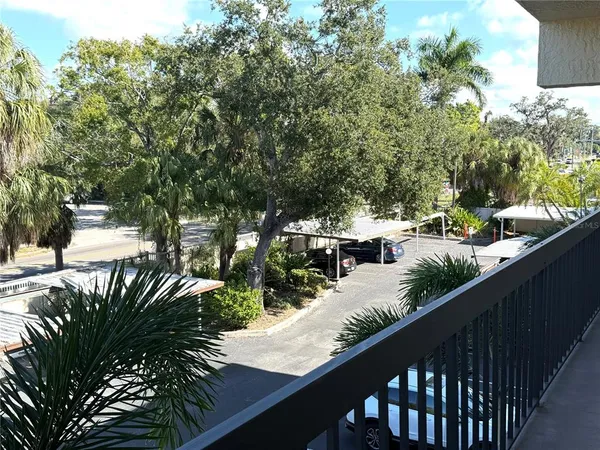 a couple of cars parked on street view from a balcony