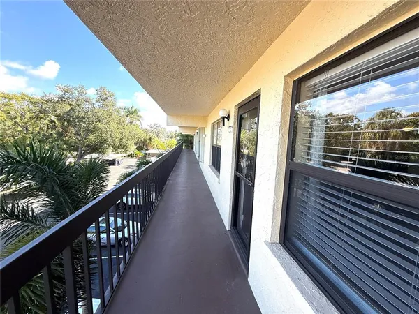 a view of balcony with wooden floor and fence