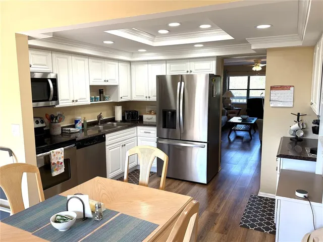 a kitchen with stainless steel appliances a refrigerator stove microwave and cabinets
